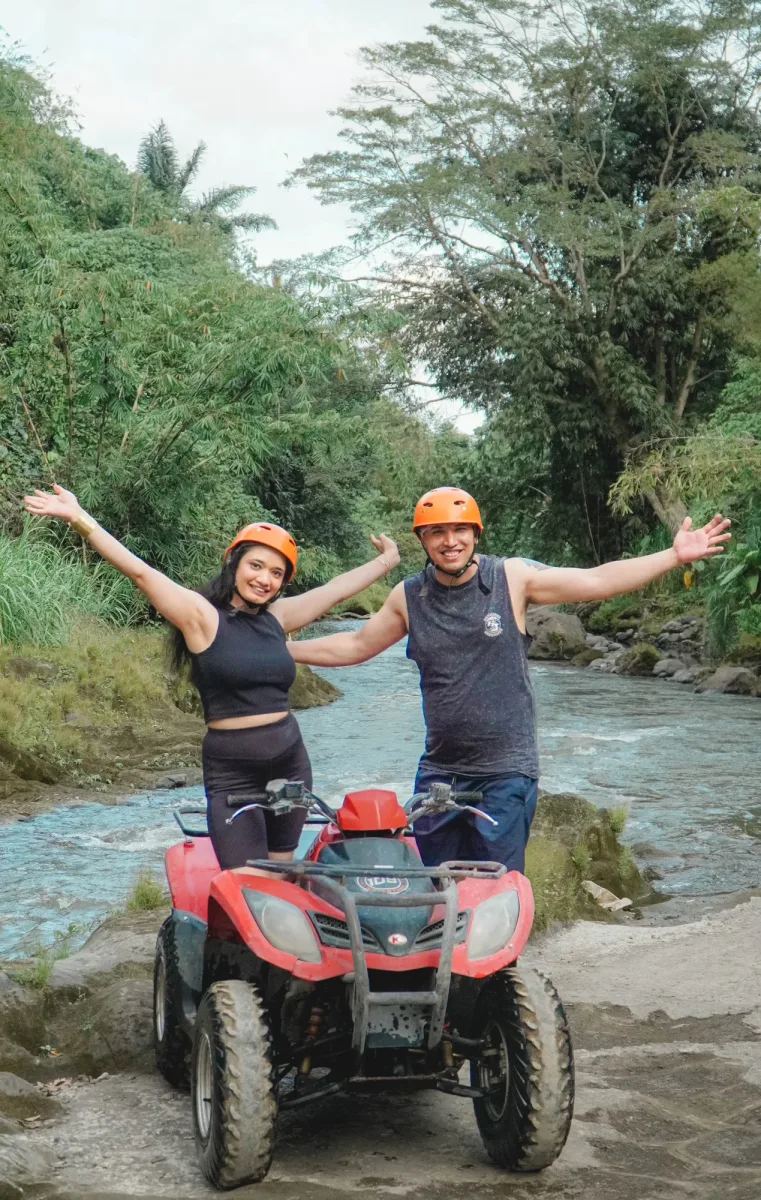 Two ATV riders crossing the river