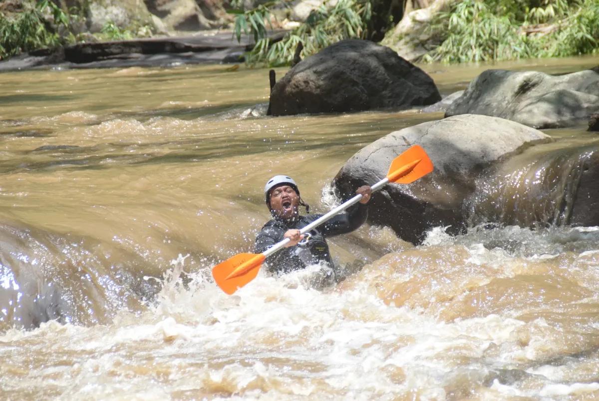Guest navigating a rocky river section in a tube